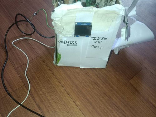 15 June — IESH v0.1 in its first enclosure: a hand-cut cardboard box with an OLED window in the front.